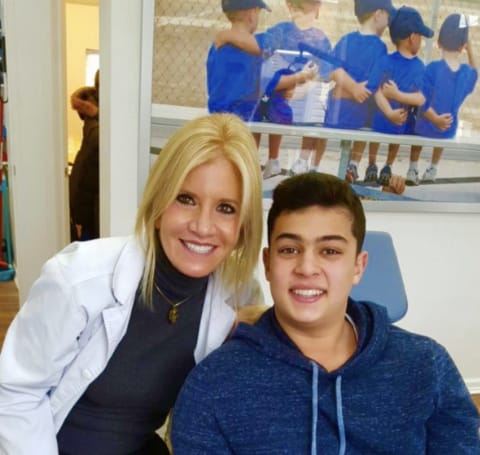 Dr. Danoff selfie with teenage boy in blue hoodie