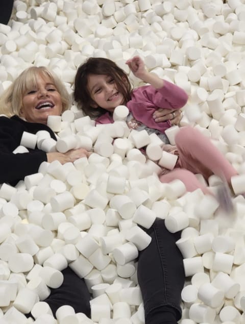 Dr. Danoff in a pit of marshmallows with young girl