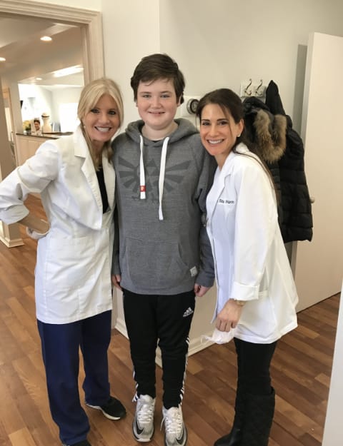 Dr. Danoff and Dr. Fromer standing with teenage boy wearing a zelda hoodie