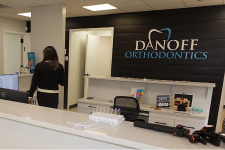 Reception area desk with danoff orthodontics sign on wall