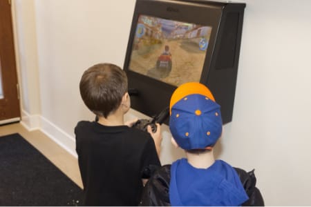 View of operatory with two operatory chairs on each side and nice artwork on the walls